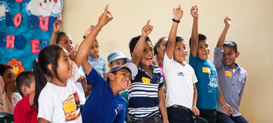 Guatemalan children with hands up