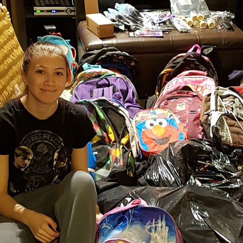 Danica with collected backpacks
