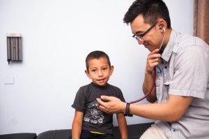 Doctor checking out young patient
