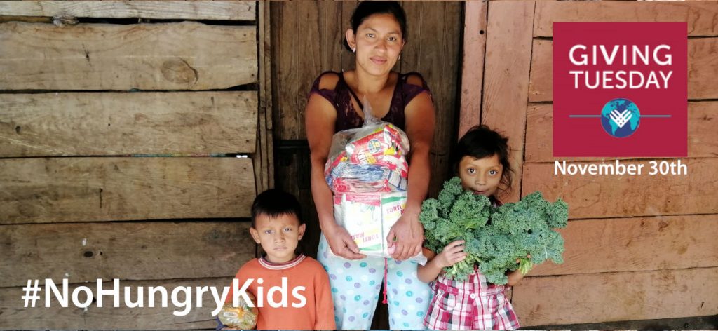 Carlos, Beverly and their mother holding a food package and fresh vegetables with the Giving Tuesday November 30th logo and the hashtag No Hungry Kids